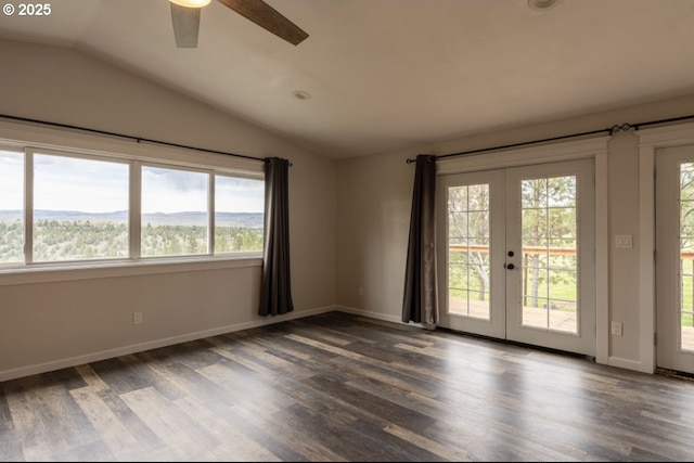 spare room with vaulted ceiling, french doors, dark wood-type flooring, and ceiling fan