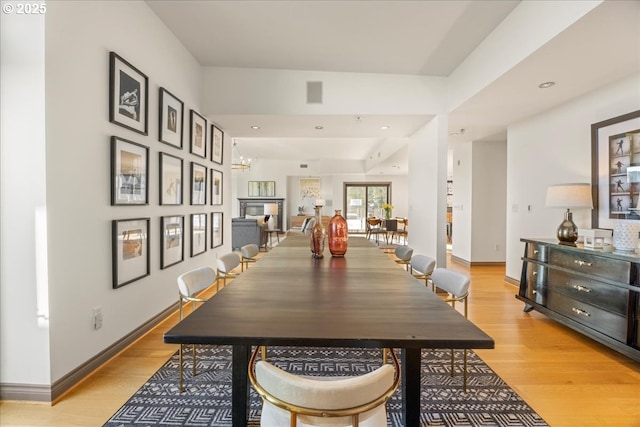 dining room with a notable chandelier and light hardwood / wood-style floors