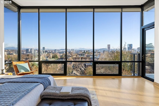 bedroom featuring floor to ceiling windows and hardwood / wood-style floors