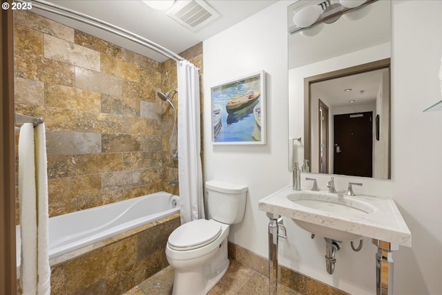 full bathroom with toilet, sink, and shower / bath combo with shower curtain