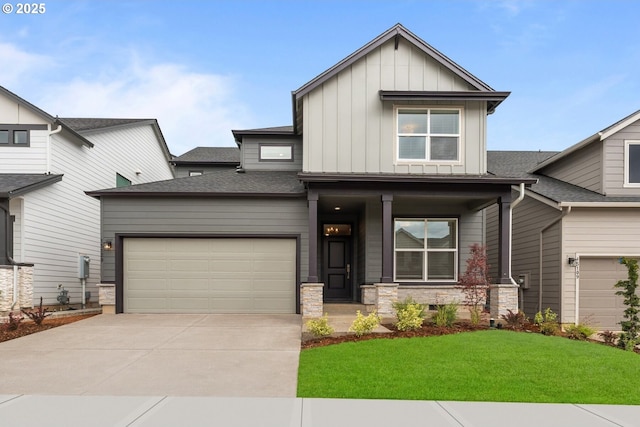 15129 SW Huntwood St, Tigard, OR 97224 - view of front of home featuring board and batten siding, a porch, driveway, a front lawn, and a garage