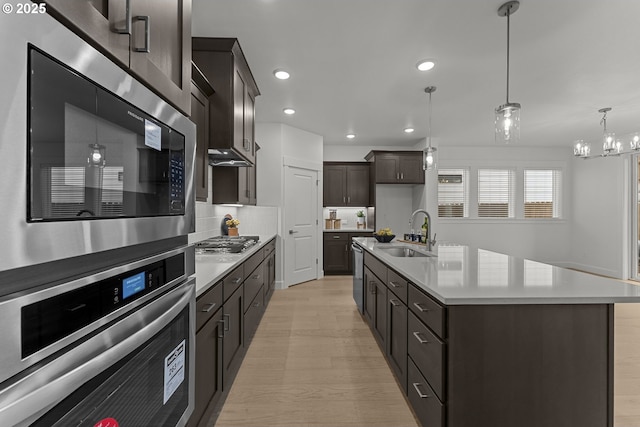 15129 SW Huntwood St, Tigard, OR 97224 - kitchen featuring a sink, stainless steel appliances, light countertops, light wood-style floors, and recessed lighting