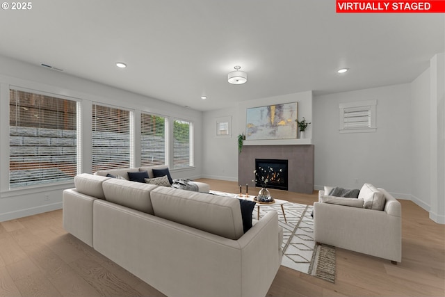 15129 SW Huntwood St, Tigard, OR 97224 - living room featuring wood finished floors, baseboards, a tiled fireplace, and recessed lighting