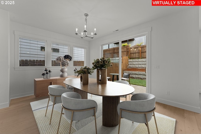 15129 SW Huntwood St, Tigard, OR 97224 - dining room with a chandelier, baseboards, and light wood-style flooring