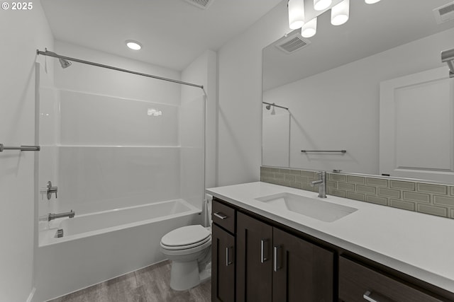 15129 SW Huntwood St, Tigard, OR 97224 - full bath featuring wood finished floors, toilet, vanity,  shower combination, and decorative backsplash