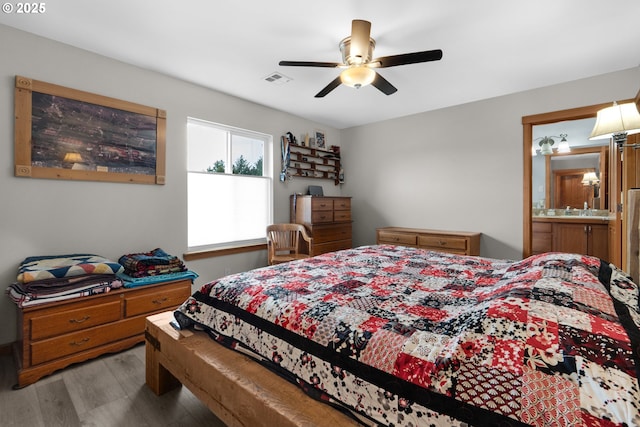 1395 Dooley Ln, Gearhart, OR 97138 - bedroom with wood finished floors, a ceiling fan, and ensuite bathroom