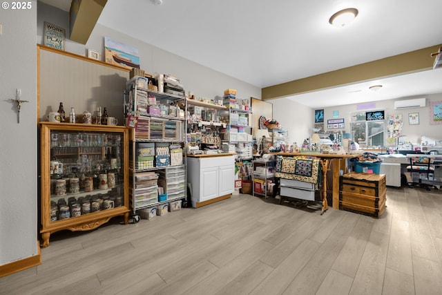 1395 Dooley Ln, Gearhart, OR 97138 - miscellaneous room with a wall mounted air conditioner and wood finished floors