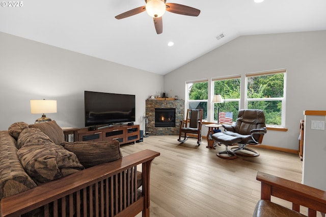 1395 Dooley Ln, Gearhart, OR 97138 - living area featuring a stone fireplace, vaulted ceiling, ceiling fan, recessed lighting, and light wood finished floors
