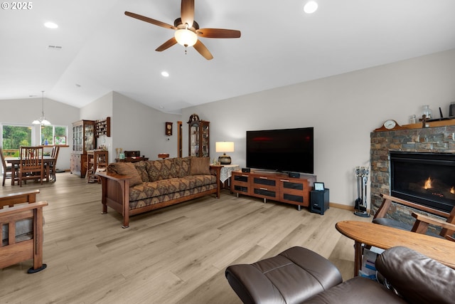 1395 Dooley Ln, Gearhart, OR 97138 - living area with vaulted ceiling, ceiling fan, wood finished floors, a stone fireplace, and recessed lighting