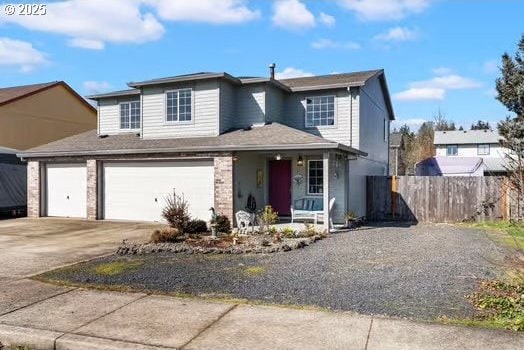 view of front of property featuring driveway, a porch, and fence