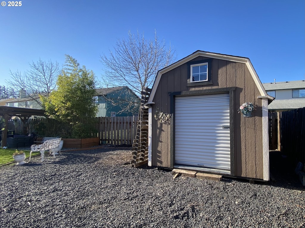 view of shed featuring fence