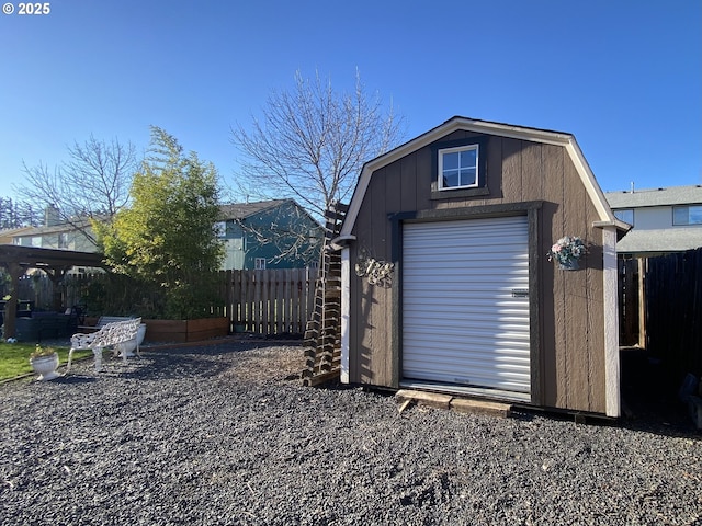 view of shed featuring fence