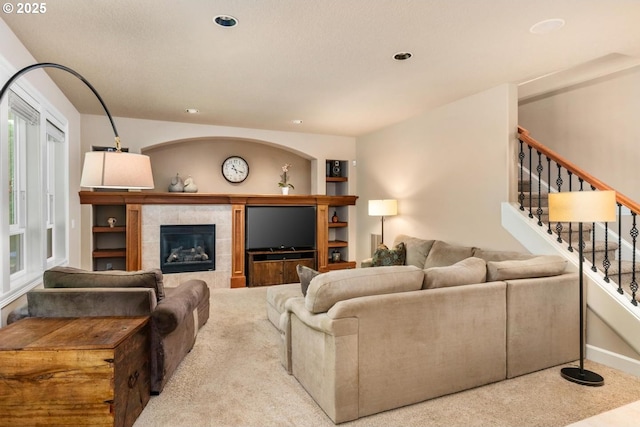 8967 SW 184th Dr, Beaverton, OR 97007 - carpeted living room with stairway, recessed lighting, a fireplace, and built in features