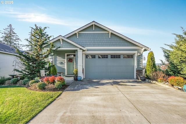 craftsman house with a garage and a front lawn