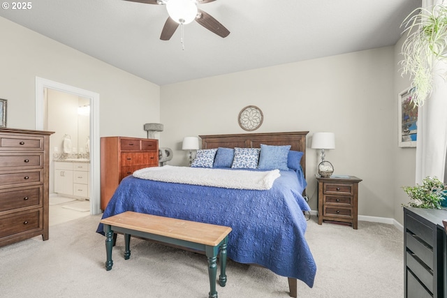 bedroom featuring ceiling fan, connected bathroom, and light carpet