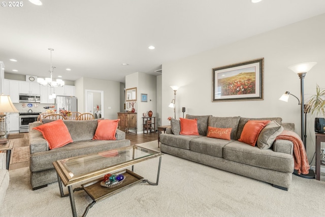 living room featuring an inviting chandelier and light wood-type flooring