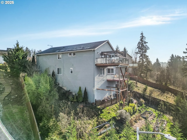 rear view of property featuring a wooden deck