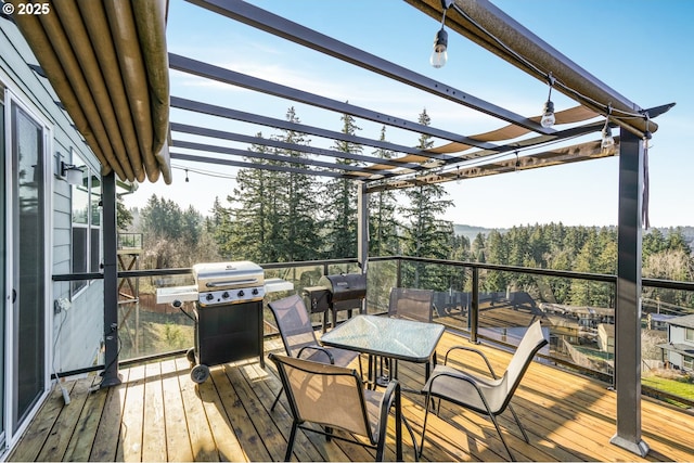 deck with a grill and a pergola