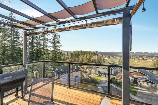 deck with grilling area and a pergola