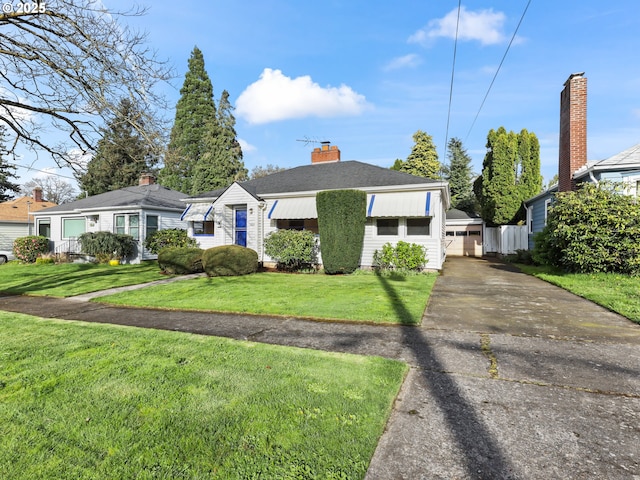 view of front facade with fence, a chimney, and a front lawn