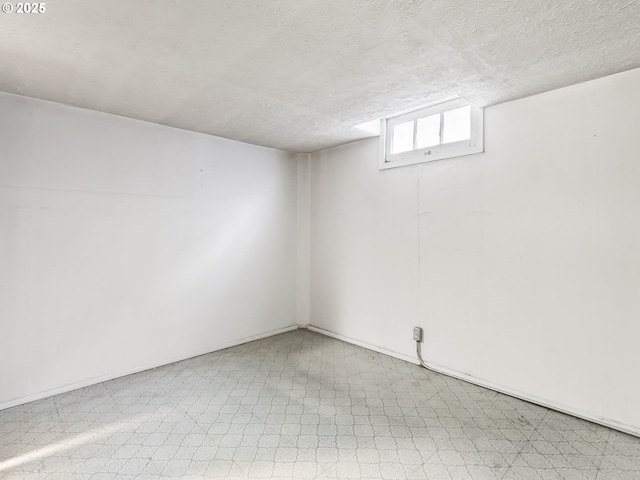 basement featuring a textured ceiling