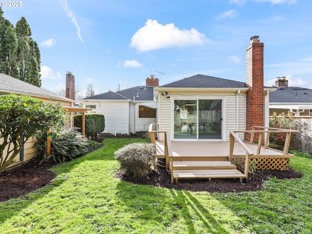 back of house featuring a wooden deck, a yard, and fence