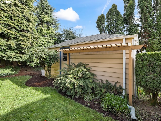 view of outbuilding with fence and a pergola