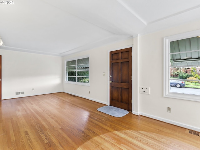 entryway with visible vents, light wood-style flooring, and baseboards