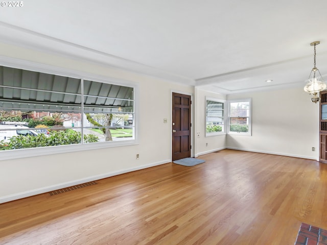 unfurnished living room with baseboards, arched walkways, wood finished floors, and a fireplace