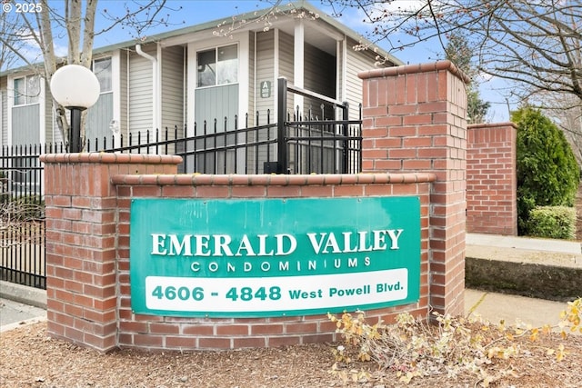 community / neighborhood sign with fence