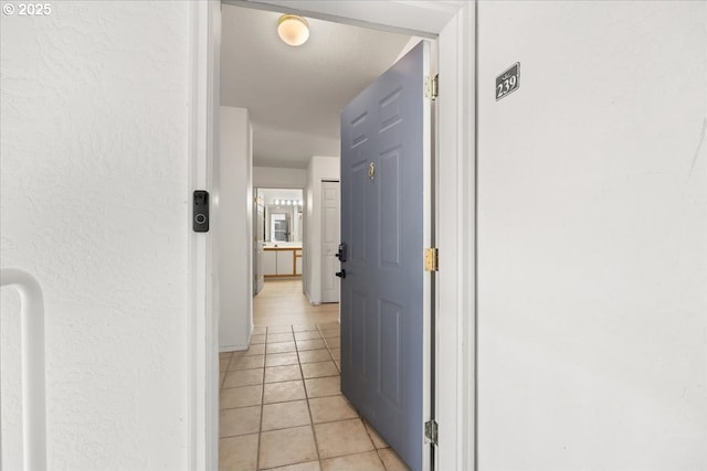 corridor with light tile patterned flooring