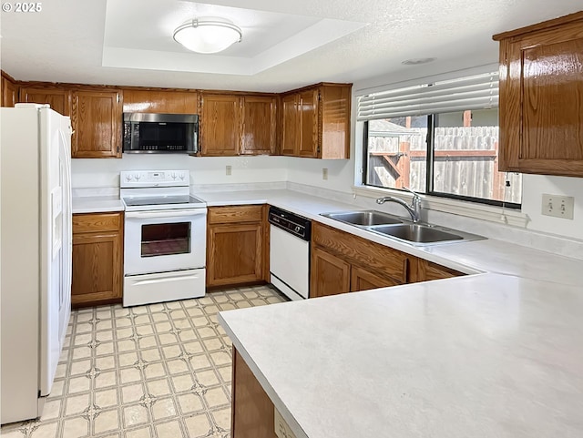 543 Linda Ln, Brookings, OR 97415 - kitchen featuring white appliances, a sink, light floors, a raised ceiling, and light countertops