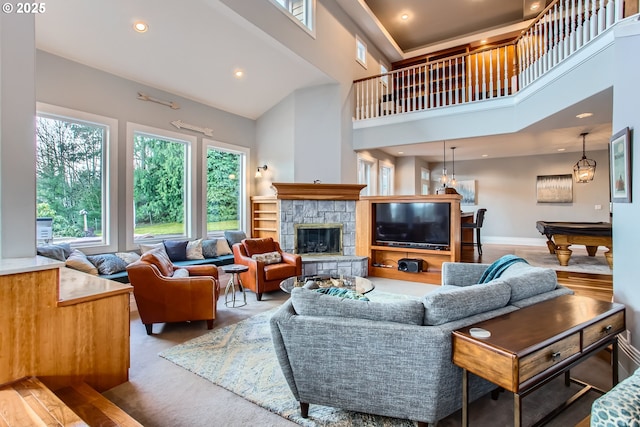 living room featuring baseboards, a towering ceiling, pool table, a fireplace, and recessed lighting