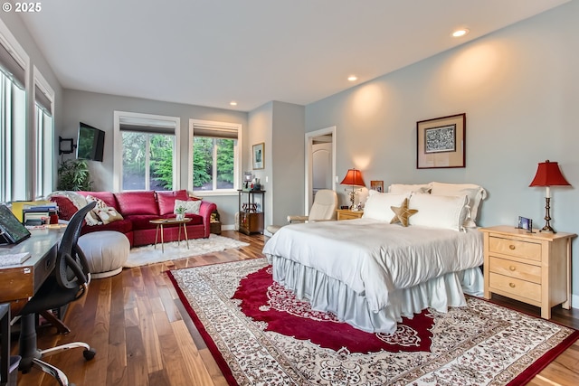 bedroom with dark wood-style floors and recessed lighting