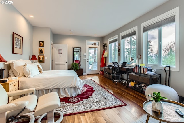 bedroom featuring access to outside, wood finished floors, and recessed lighting