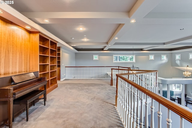 hallway featuring coffered ceiling, beamed ceiling, an inviting chandelier, carpet, and recessed lighting