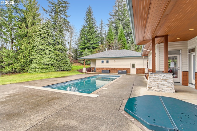 outdoor pool with a patio area