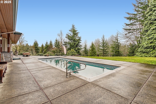 outdoor pool with a yard and a patio