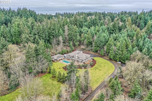 birds eye view of property with a view of trees