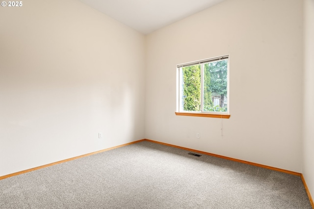 carpeted spare room with baseboards and visible vents