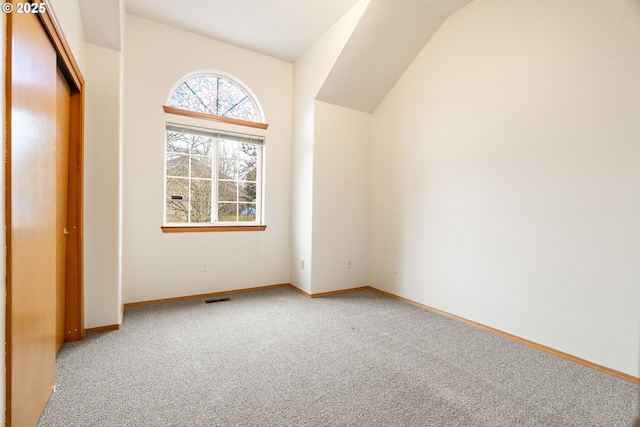 bonus room with baseboards, visible vents, and carpet flooring