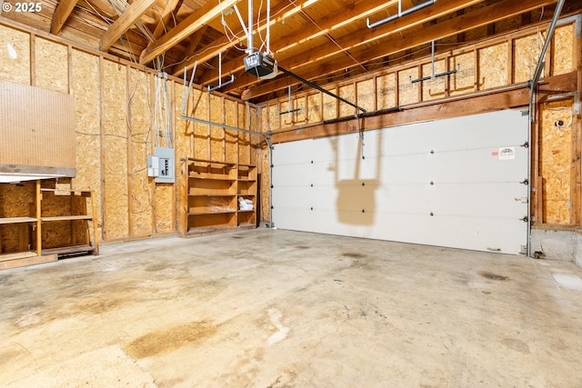 garage with electric panel and a garage door opener