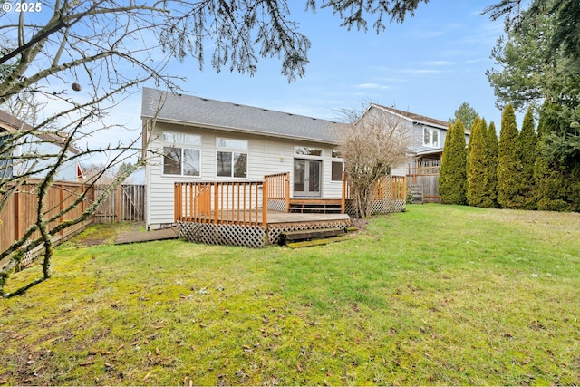 back of house with a deck, a yard, and a fenced backyard