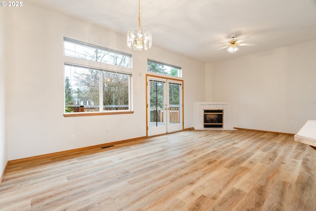 unfurnished living room featuring a fireplace, visible vents, baseboards, and light wood-style floors