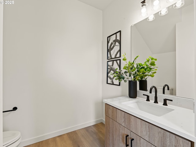 7090 N Leonard Ave Unit 1, Portland, OR 97203 - bathroom with vanity, toilet, baseboards, and wood finished floors
