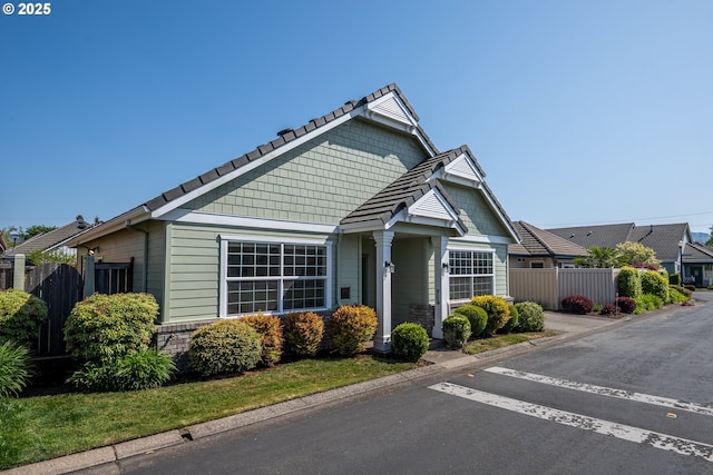 view of front of property featuring fence and uncovered parking