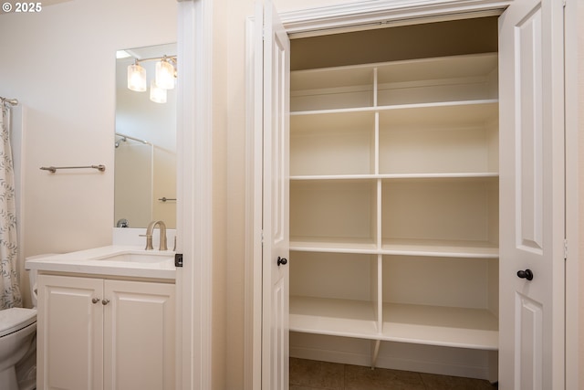 bathroom with vanity, tile patterned flooring, and toilet