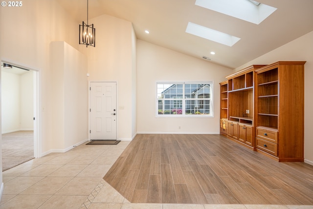 entrance foyer with recessed lighting, high vaulted ceiling, visible vents, and light wood-style floors
