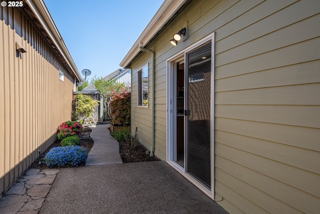 view of side of property with a patio area