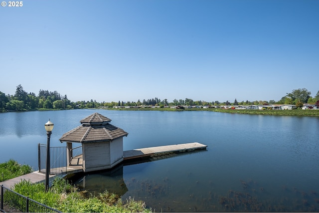 view of dock with a gazebo and a water view